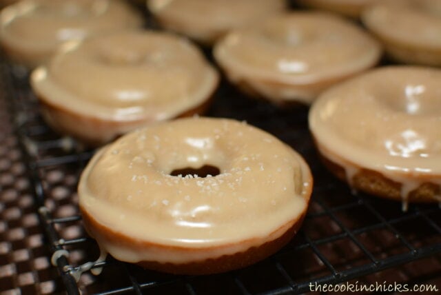 baked apple cider donuts on a wire rack.