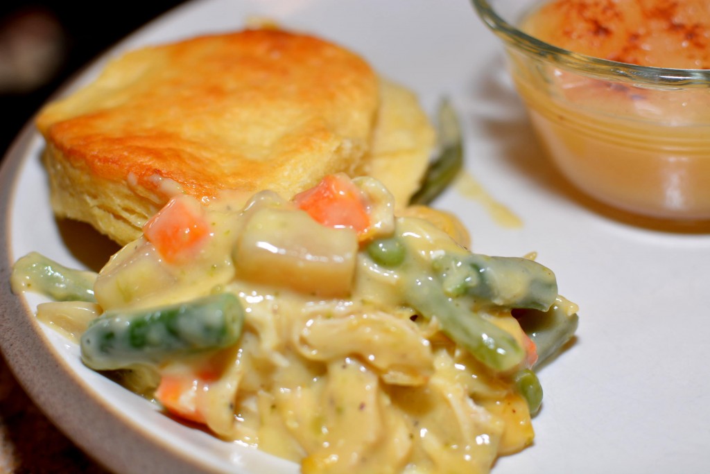 fluffy and tender biscuits on top of a creamy chicken and vegetable mixture
