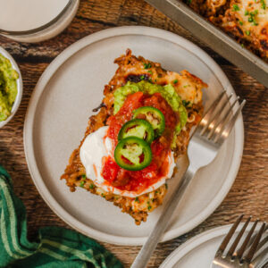 a serving of walking tacos on a plate with toppings.