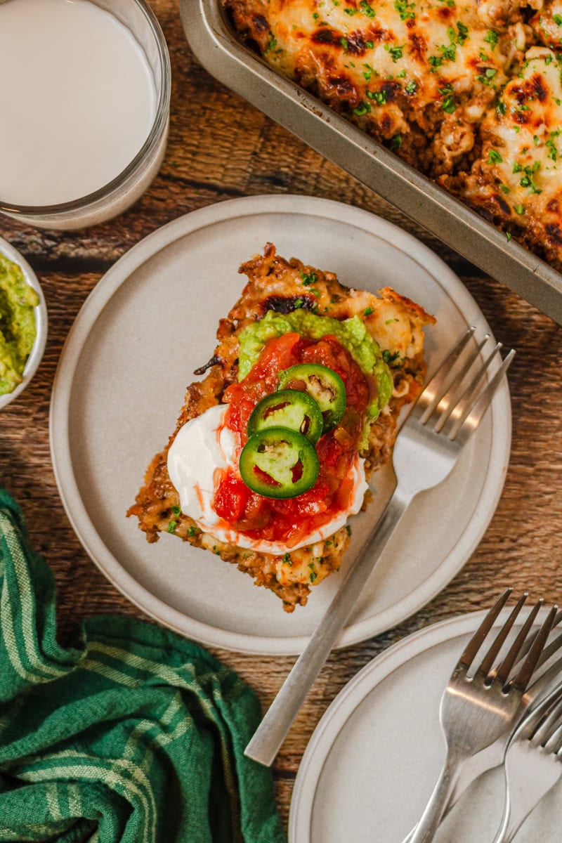 a serving of walking tacos on a plate with toppings.