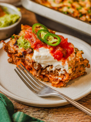 jalapenos, sour cream, and tomatoes over a piece of taco casserole.