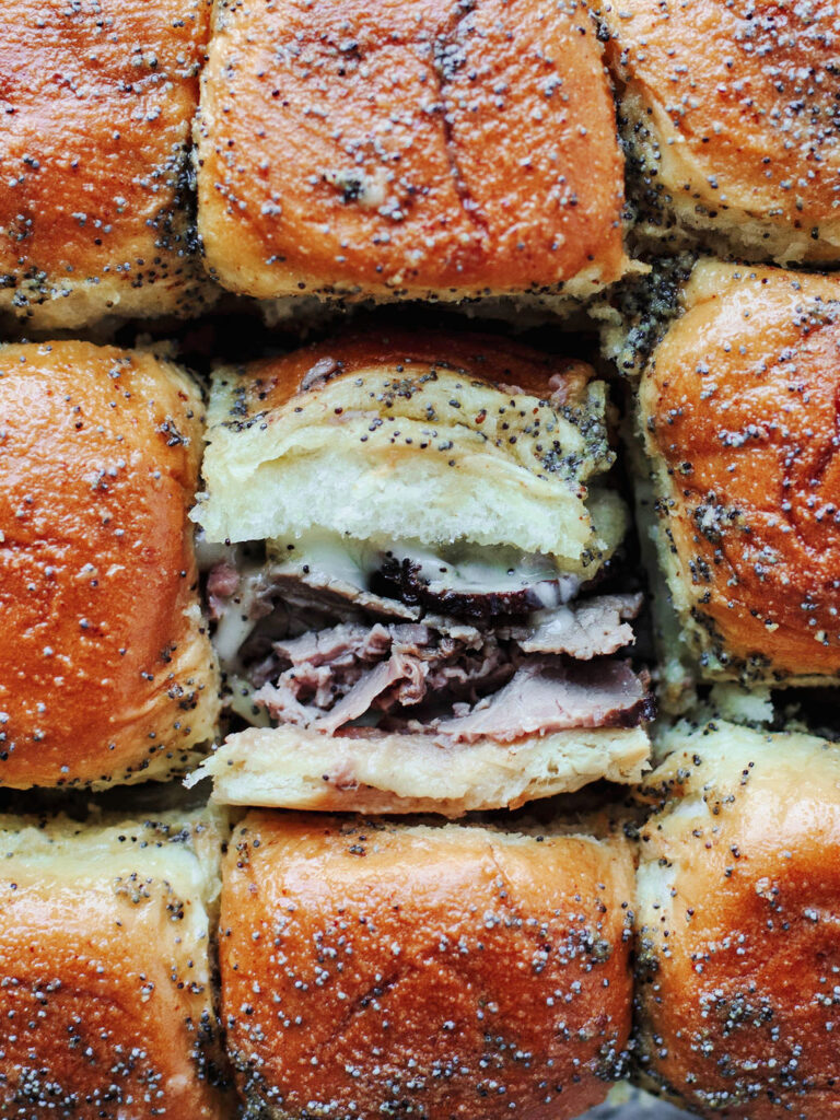 a tender slider stuffed with roast beef, Swiss cheese, and topped with Dijon glaze.