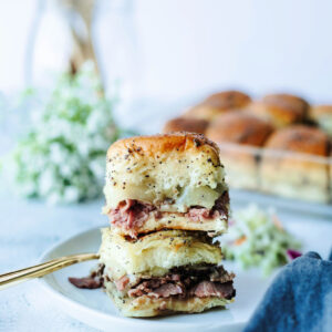 a stack of sandwiches on a plate ready to eat.
