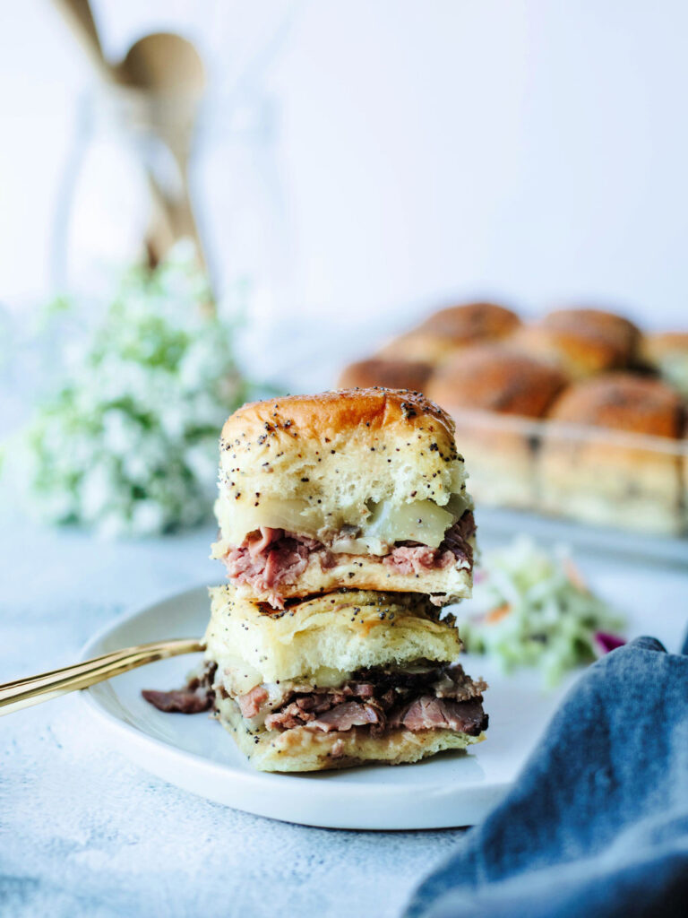 a stack of sandwiches on a plate ready to eat.