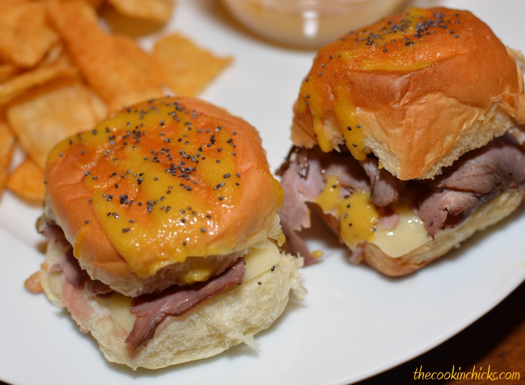 Roast beef sliders are the perfect game day food! Layers of roast beef and cheese between Hawaiian rolls are topped with the most delicious spread and cooked to perfection.