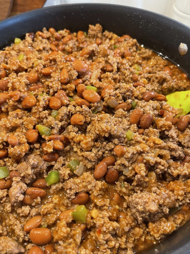 ground beef cooked with taco seasonings, peppers, and served over fritos
