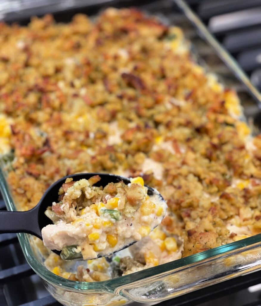 a scoop of chicken stuffing bake ready to serve