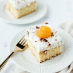 a fluffy yellow cake with tropical flavors on a white serving plate.