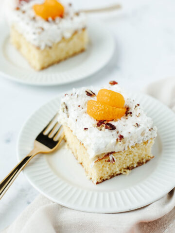 a fluffy yellow cake with tropical flavors on a white serving plate.
