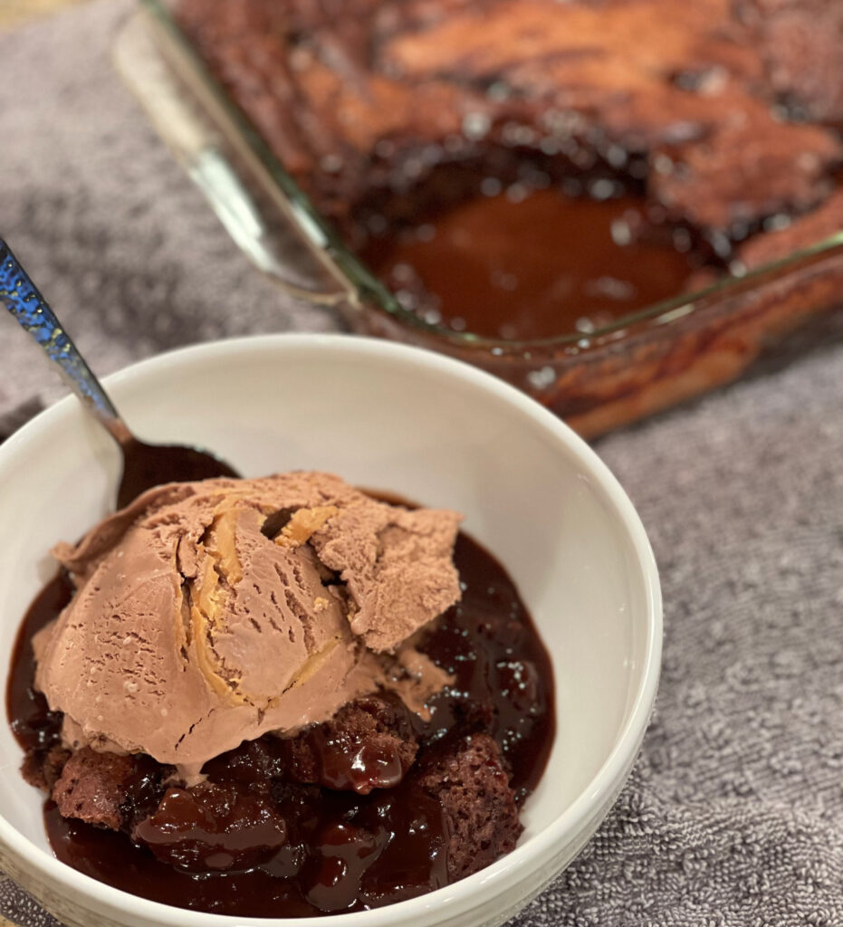 hot fudge pudding cake served in a bowl with ice cream