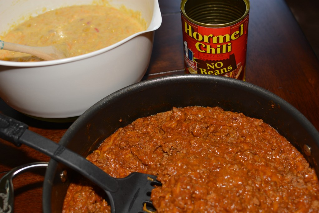 seasoned ground meat with chili beans, cheese, and cornbread