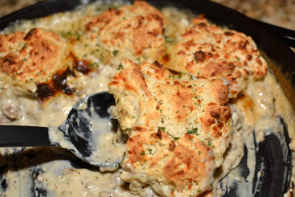 creamy sausage gravy with biscuits cooked in a cast iron skillet