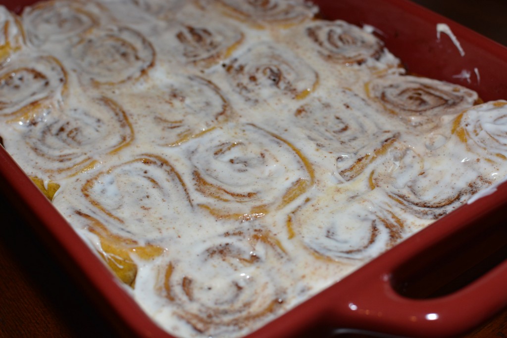 Incredible cream cheese frosting smothered over fluffy pumpkin cinnamon rolls