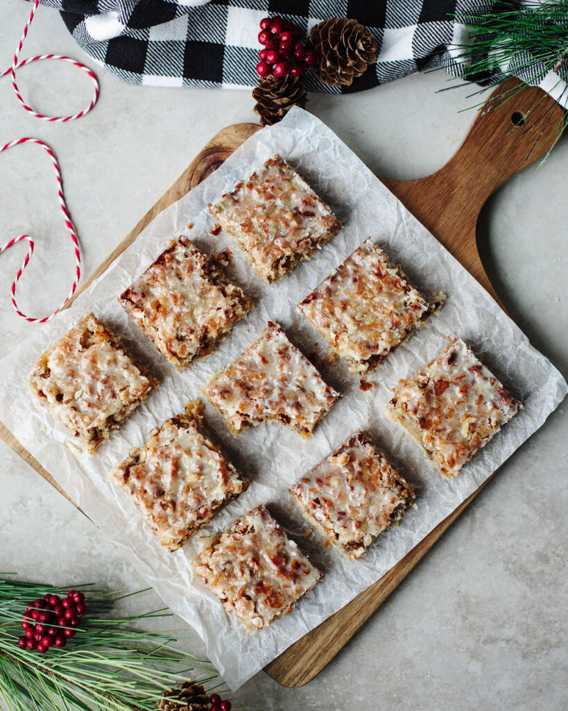 lemon dream bars cut on a wood board.