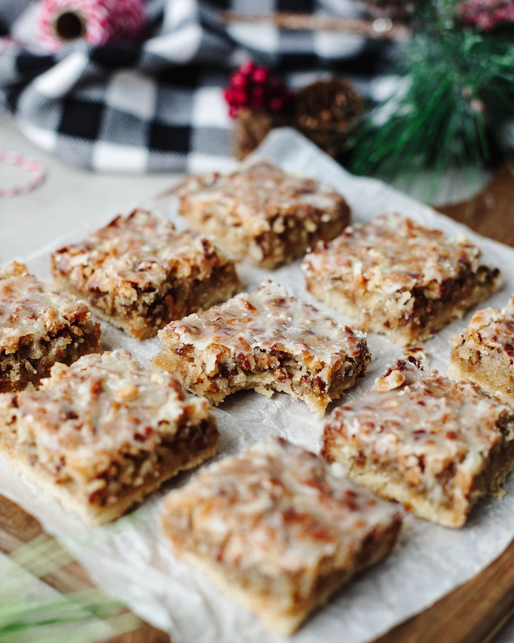 lemon dream bars sliced on a white parchment paper.