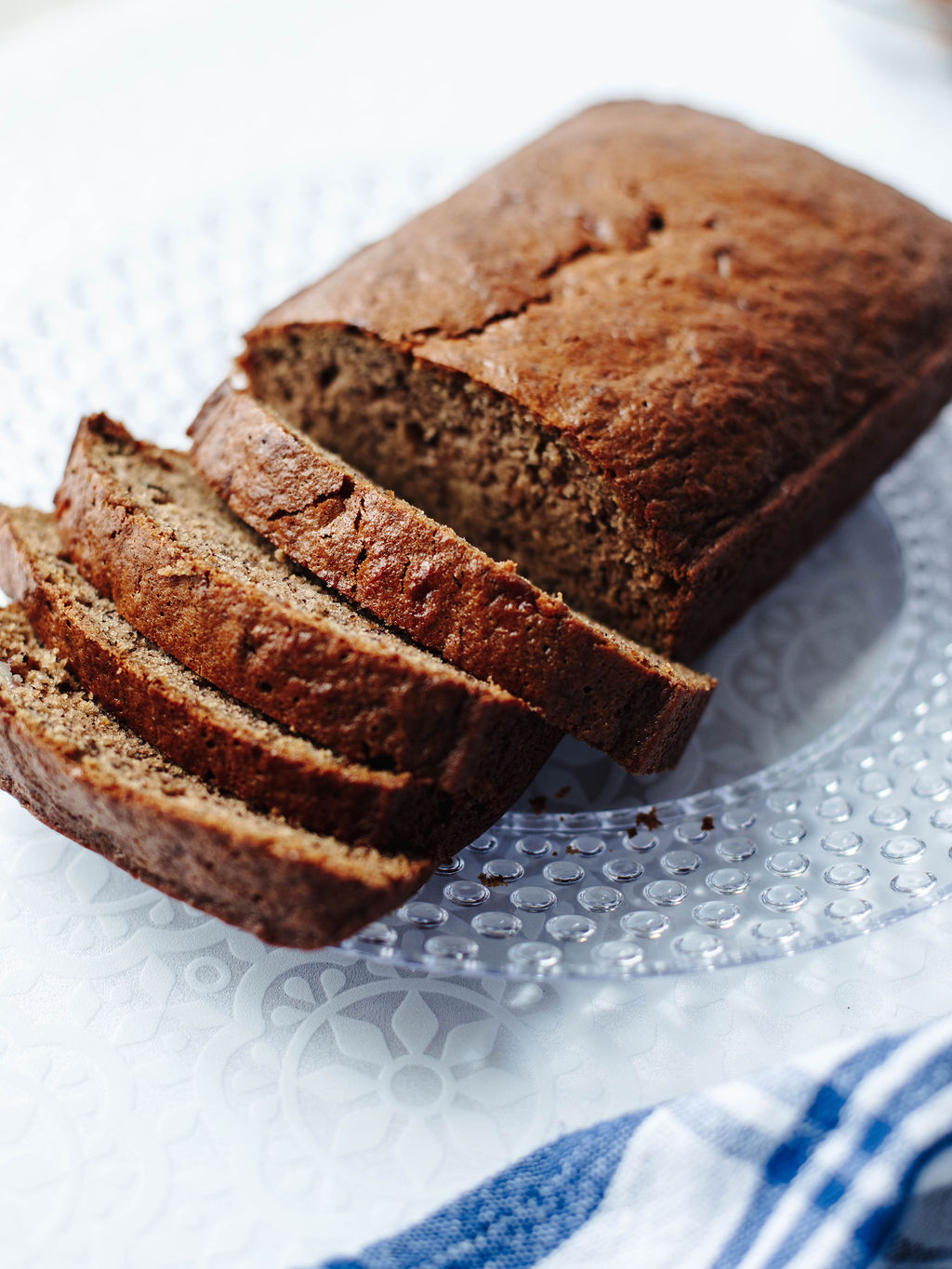 moist and flavorful mayonnaise banana bread sliced and served on a plate.