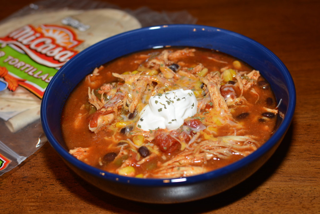 chicken, corn, beans, tomatoes, and seasonings cooked in the slow cooker for a flavorful chicken tortilla soup 