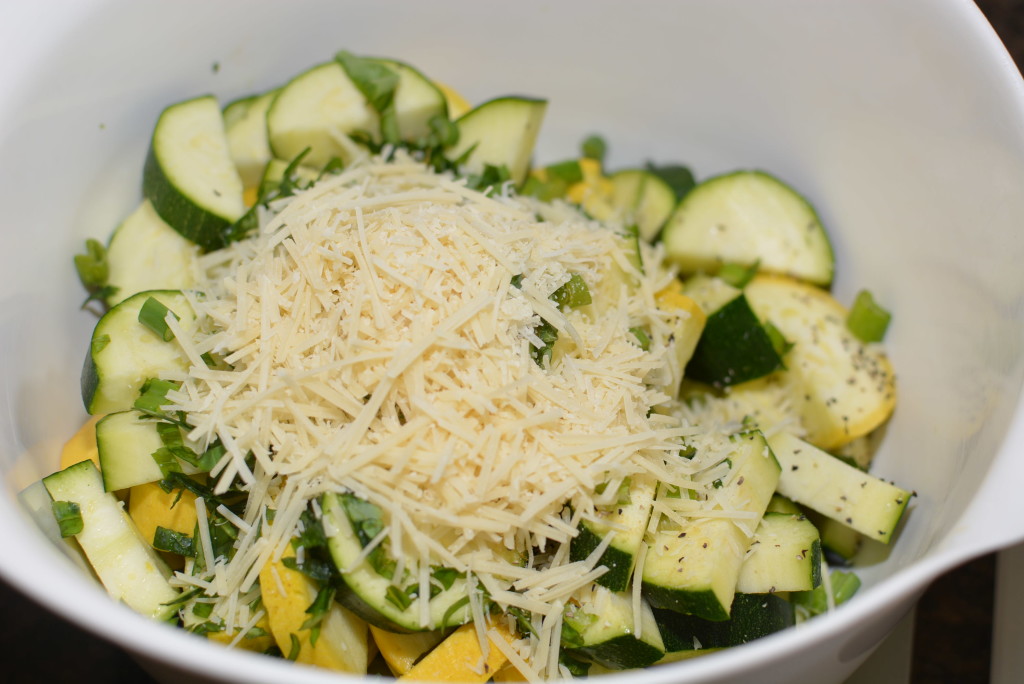 cheese on top of zucchini, squash, and basil