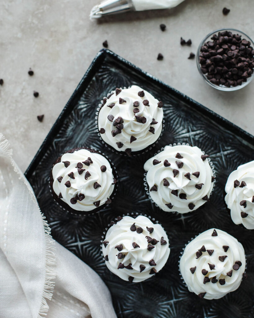 a frosted chocolate cupcake with sprinkles.