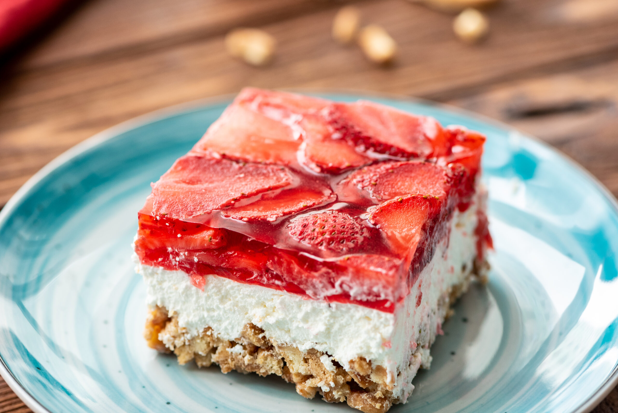 a piece of strawberry pretzel Jello salad on a serving plate.