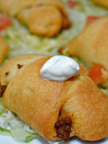 taco seasoned beef stuffed into crescents and served with favorite toppings