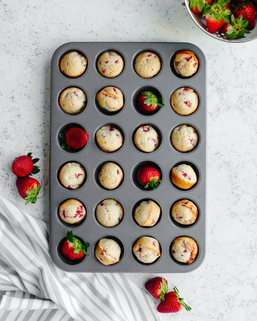 mini strawberry muffins baked in a muffin tin.
