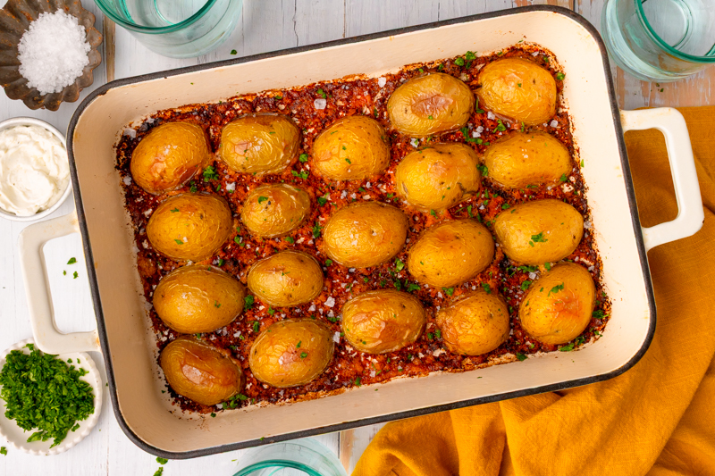 a baking dish with roasted Potatoes ready to serve.