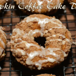 pumpkin coffee cake donuts on a wire cooling rack.