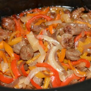 tender peppers and onion with sausage cooked in the slow cooker