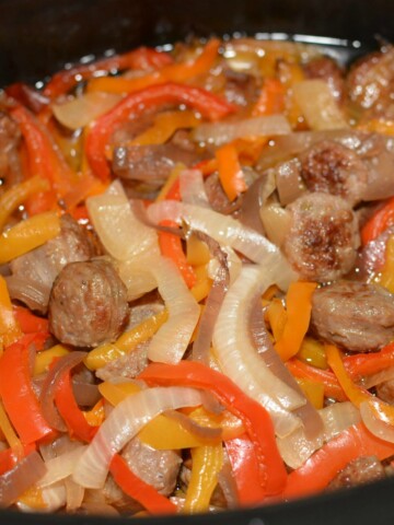 tender peppers and onion with sausage cooked in the slow cooker