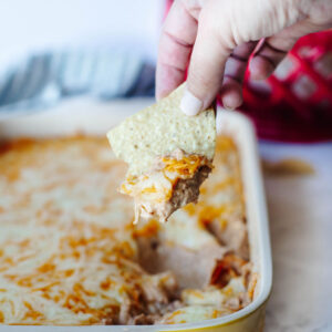 a warm, cheesy bean dip on a tortilla chip.