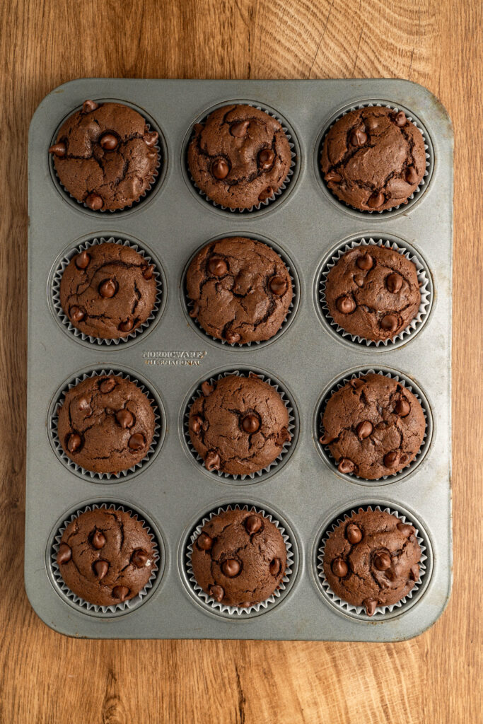 chocolate muffins baked in a muffin pan ready to enjoy.