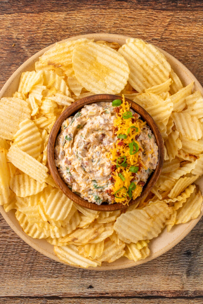 a serving tray with potato chips and a mayonnaise based recipe.