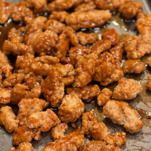 crispy fried chicken coated in a sweet and savory sauce