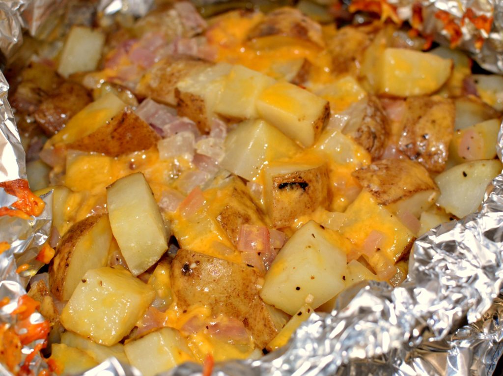 Warm and cheesy garlic potatoes in a foil packet from the grill!