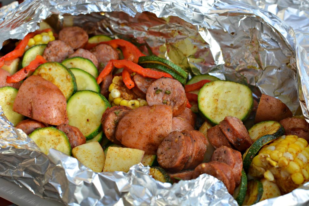 sausage and veggies cooked in a tin foil packet on the grill