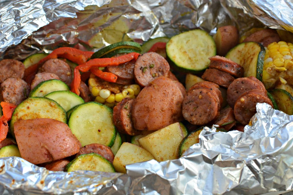 tender vegetables and sausage cooked in a tin foil packet over the grill