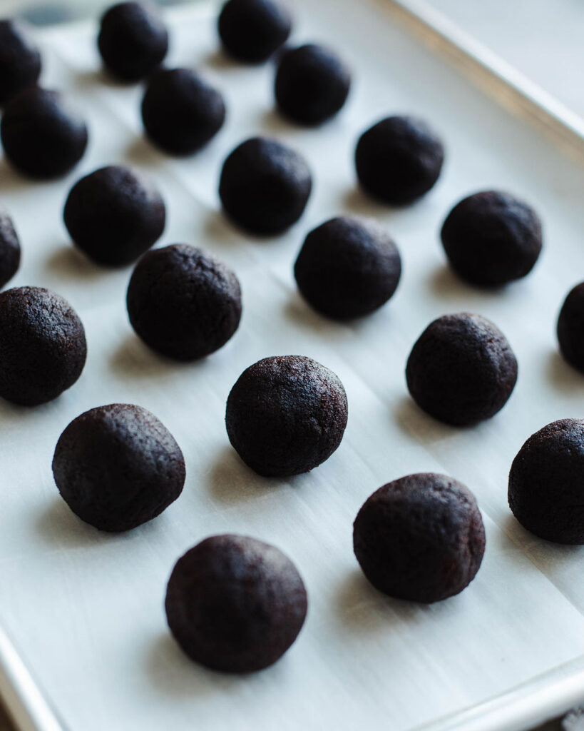 rolled cake balls ready to go to a freezer to set up.
