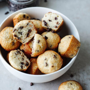 a white bowl with Mini Chocolate Chip Muffins.