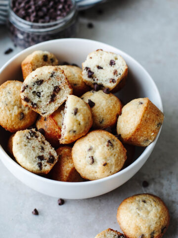 a white bowl with Mini Chocolate Chip Muffins.