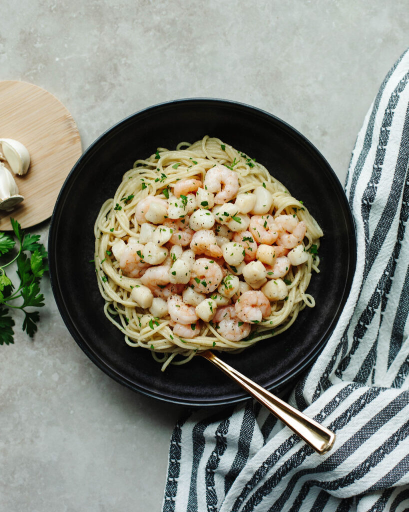 Garlic Butter Grilled Shrimp and Scallops served over pasta.