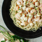 a seafood dinner made with three ingredients over a bed of pasta.