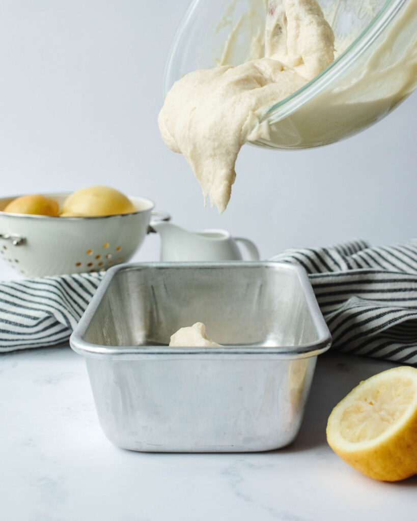 quick bread batter being poured into a loaf pan.