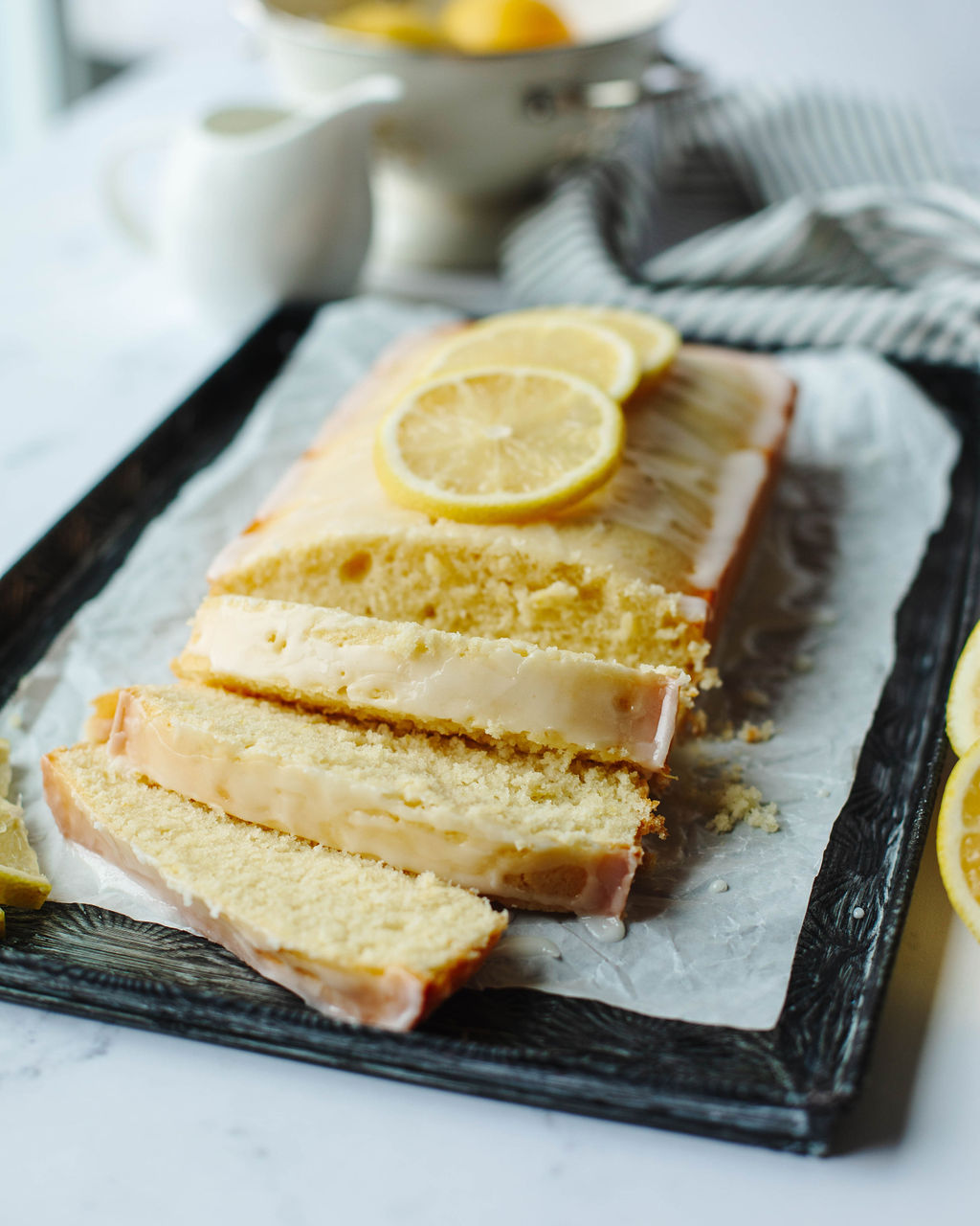 lemon quick bread sliced on a cutting board.