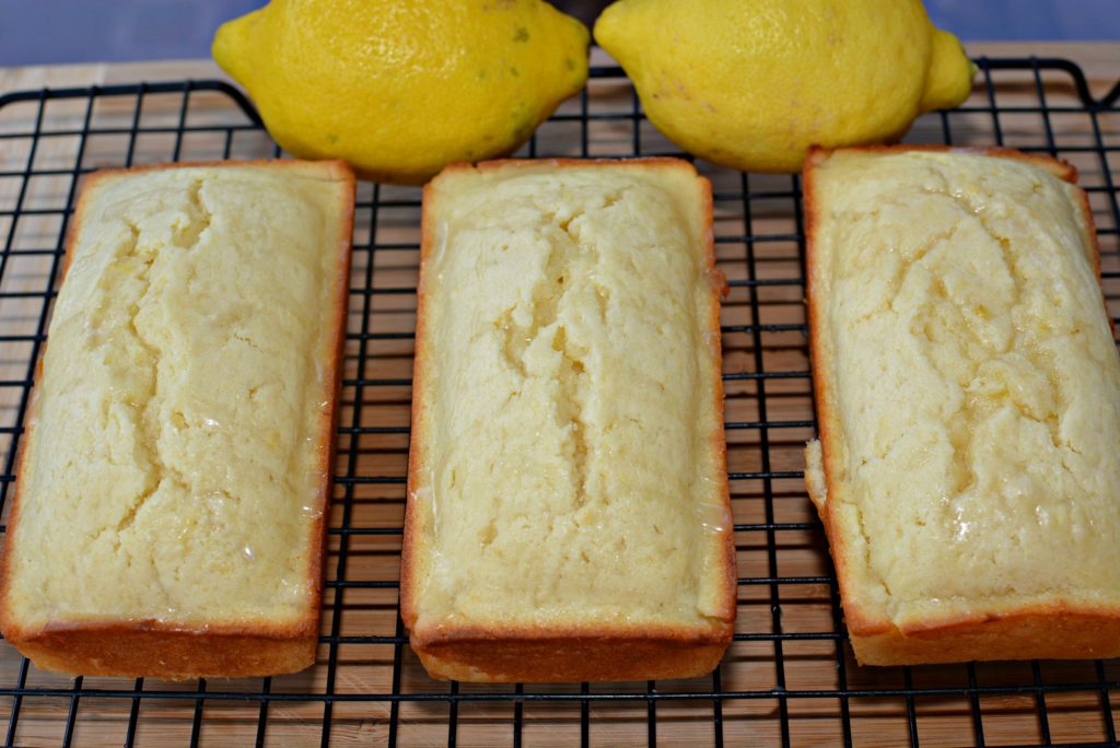 Lemon bread with fresh lemons on the cooling rack
