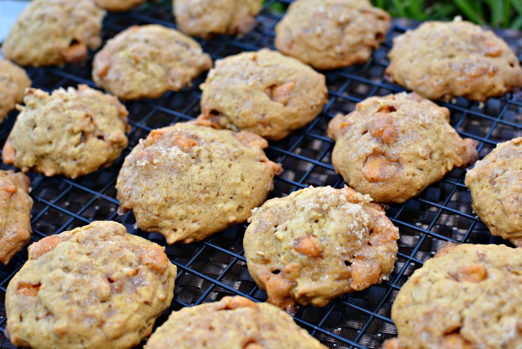 Brown sugar sprinkled on top of pumpkin cookies with butterscotch chips throughout