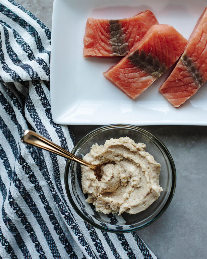 mayonnaise, cheese, and seasoning combined in a bowl to spread over salmon.