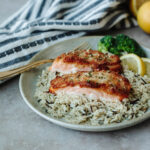tender salmon with a crispy crust on a bed of rice.