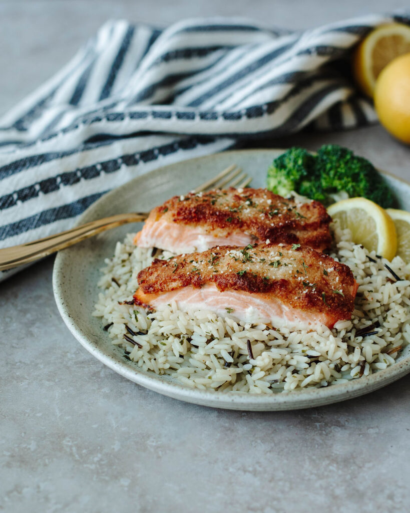 tender salmon with a crispy crust on a bed of rice.