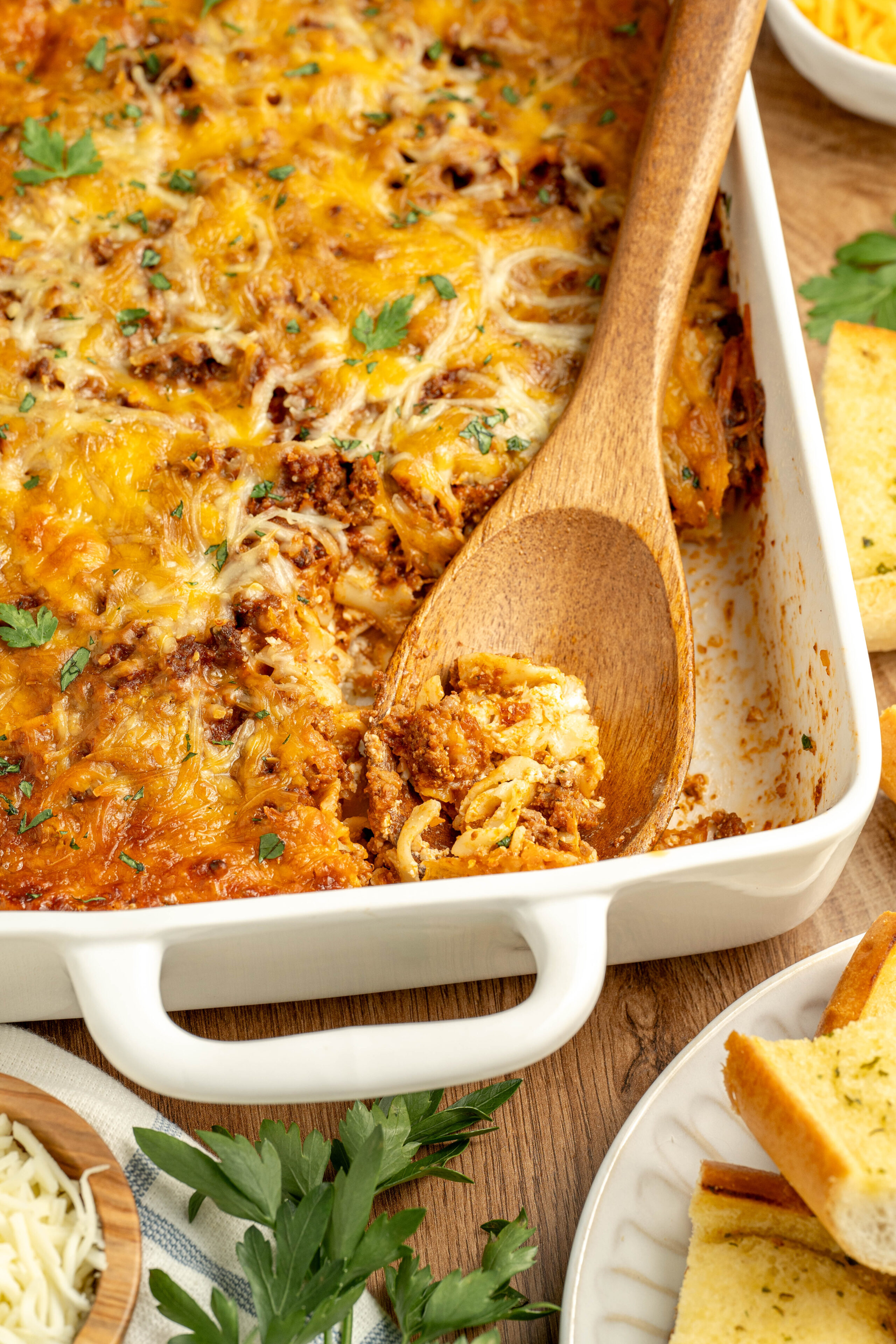 a cheesy Italian pasta casserole with ground beef in a baking pan.